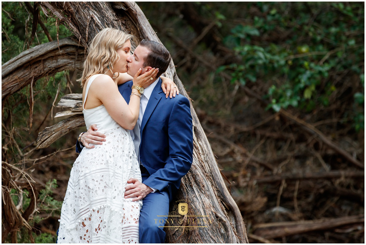Austin engagement session bride kissing groom against tree