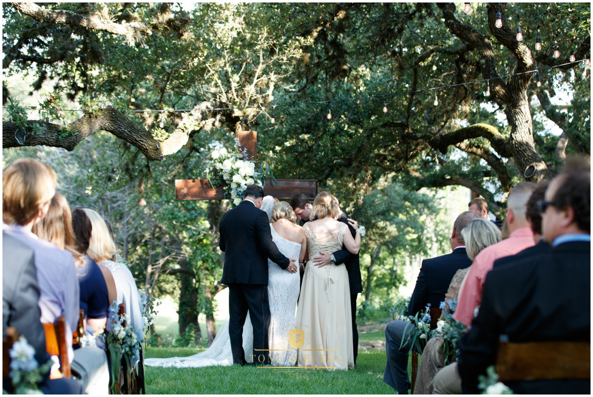 austin wedding photographer ivory oak family prayer ceremony from behind