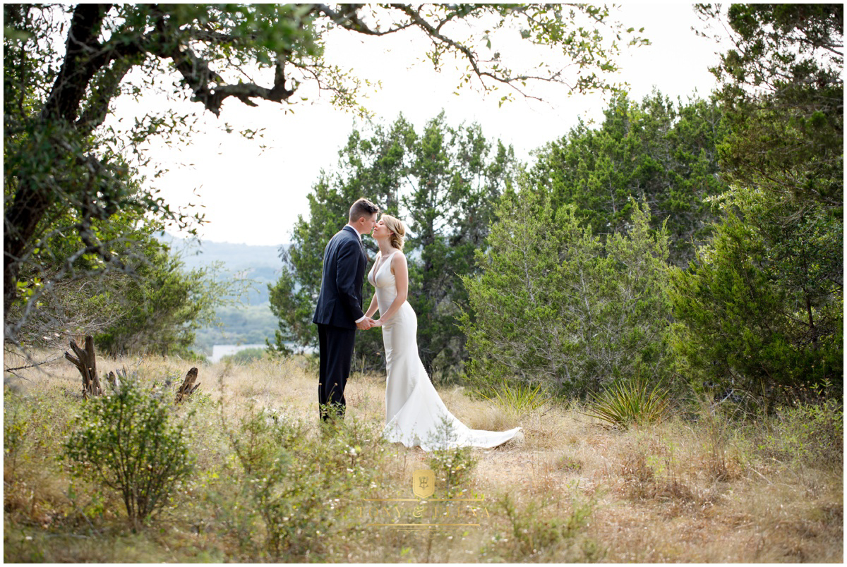 Austin wedding photographer terrace club bride groom kissing great hill country view